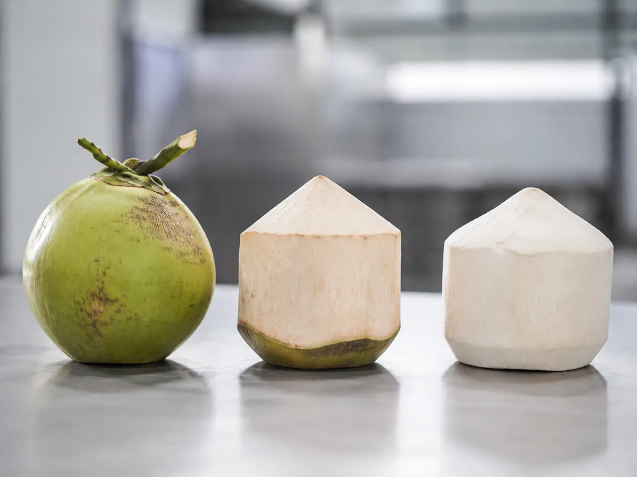 Green-husk, diamond-shaped and polished Thai Nam Hom coconut presentations